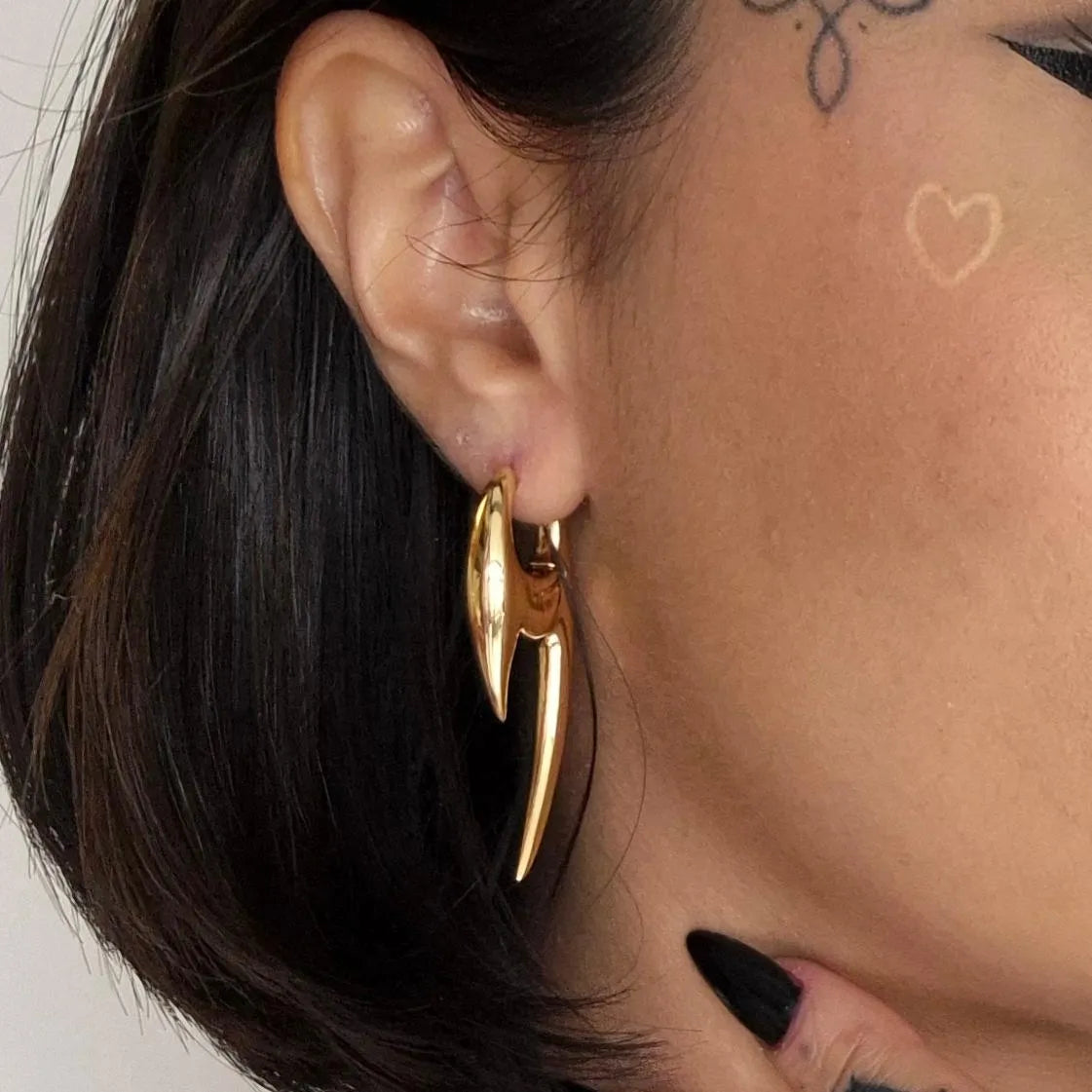 Gold Scorpion Claw Earrings styled on model with curved scorpion pincer shape and bold gothic jewelry look
