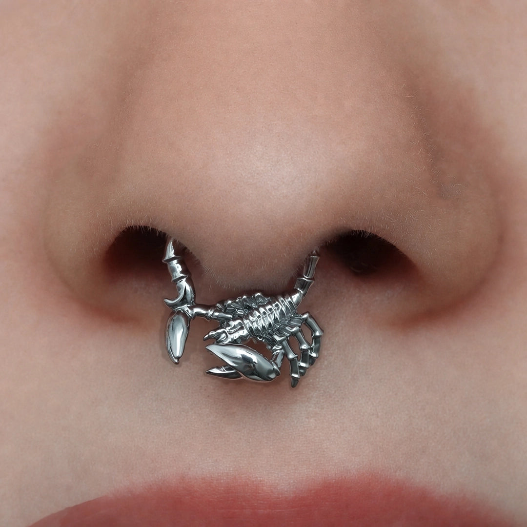 Silver-tone Scorpion Empowerment Clicker worn as a septum ring, featuring a detailed scorpion design.