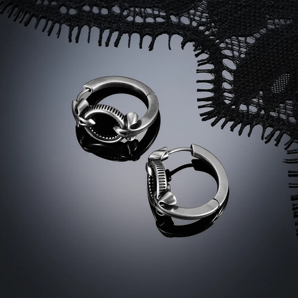 Antiqued silver-tone Scrying Mirror Hoop Earrings displayed from multiple angles on a dark reflective surface.