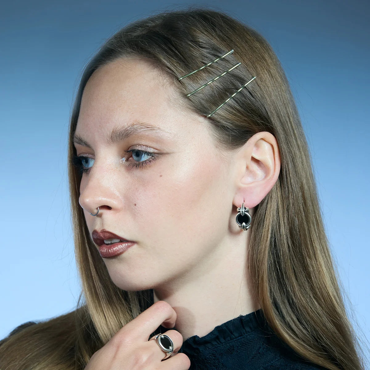Antiqued silver-tone Scrying Mirror Hoop Earring worn in a three-quarter portrait, highlighting the oval black obsidian inlay.