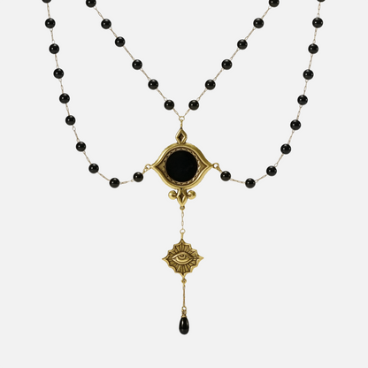 Gold-tone Scrying Mirror Necklace displayed from the front with doubled black bead chains, an oval black obsidian centerpiece, and a teardrop accent.