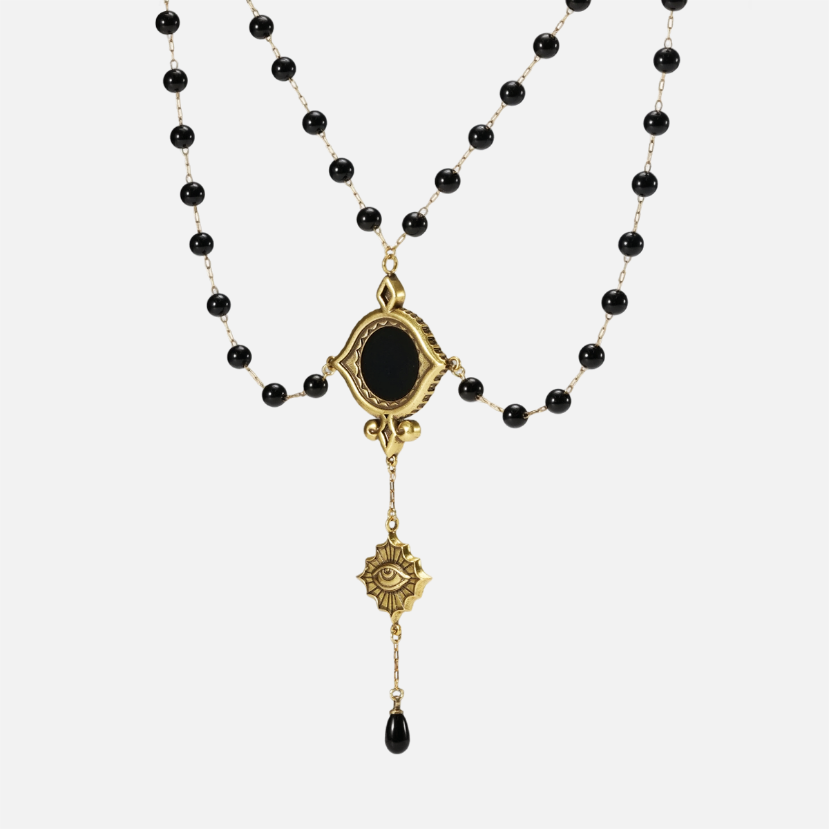 Full front view of the gold-tone Scrying Mirror Necklace with doubled black bead chains, a black obsidian centerpiece, and a long central drop.