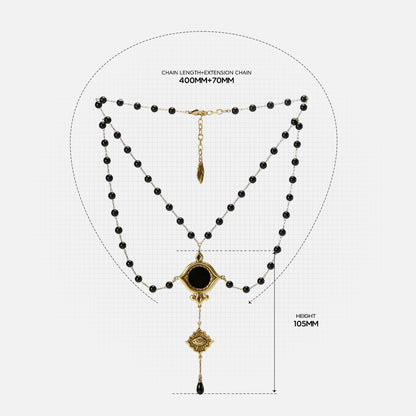 Size guide for the gold-tone Scrying Mirror Necklace showing the doubled bead chains, centerpiece, central drop, and overall dimensions.