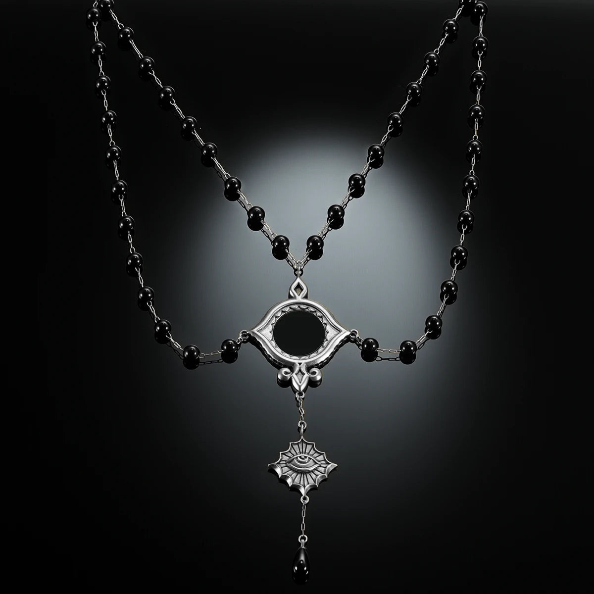 Antiqued silver-tone Scrying Mirror Necklace displayed against black lace on a dark reflective surface.