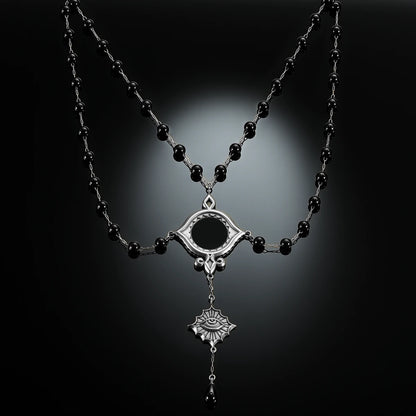 Antiqued silver-tone Scrying Mirror Necklace displayed against black lace on a dark reflective surface.