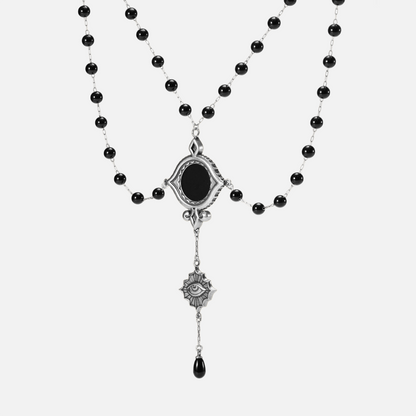 Full front view of the antiqued silver-tone Scrying Mirror Necklace with doubled black bead chains and an elongated symbolic drop.