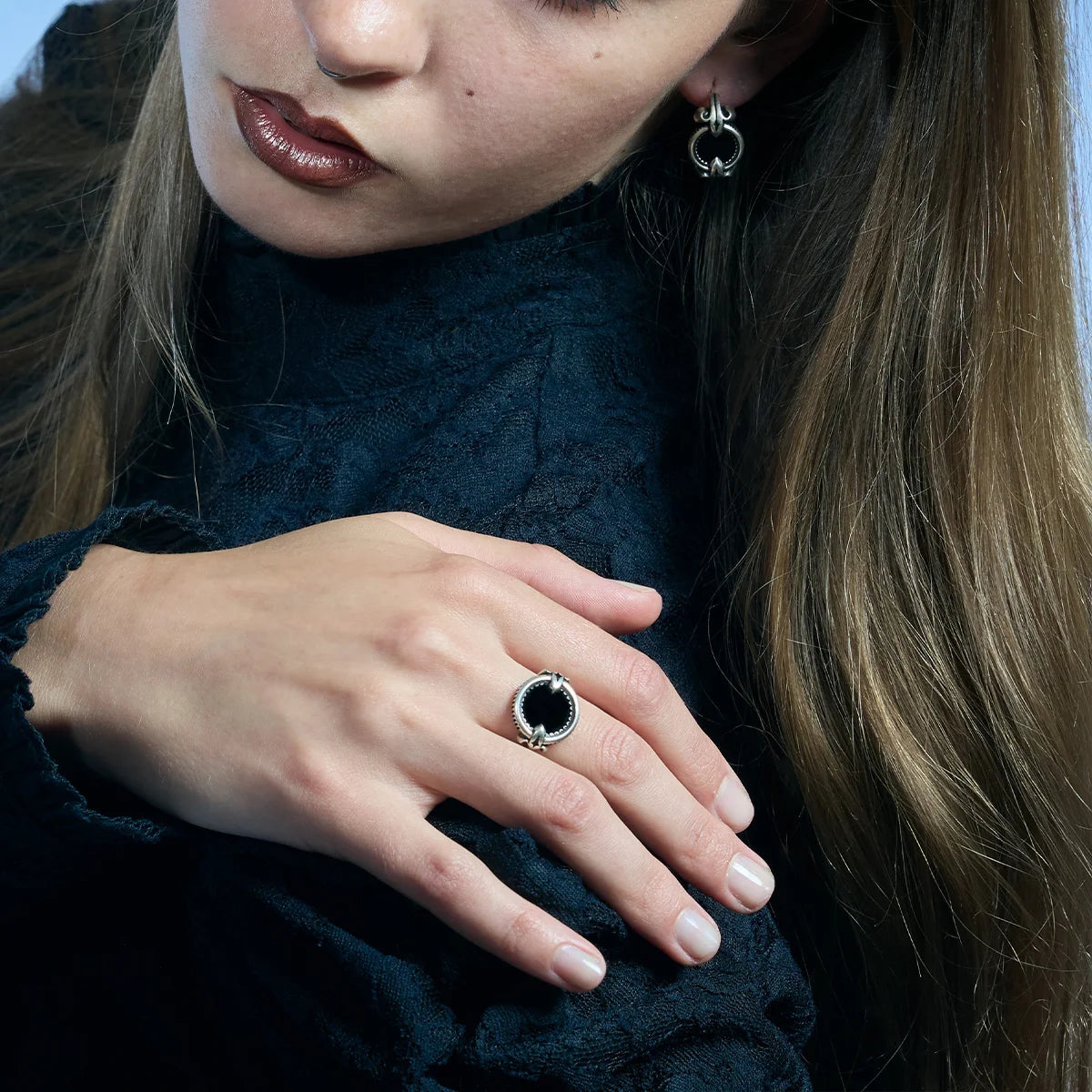 Antiqued silver Scrying Mirror Ring worn in a downward-looking portrait, highlighting the circular black obsidian centerpiece.