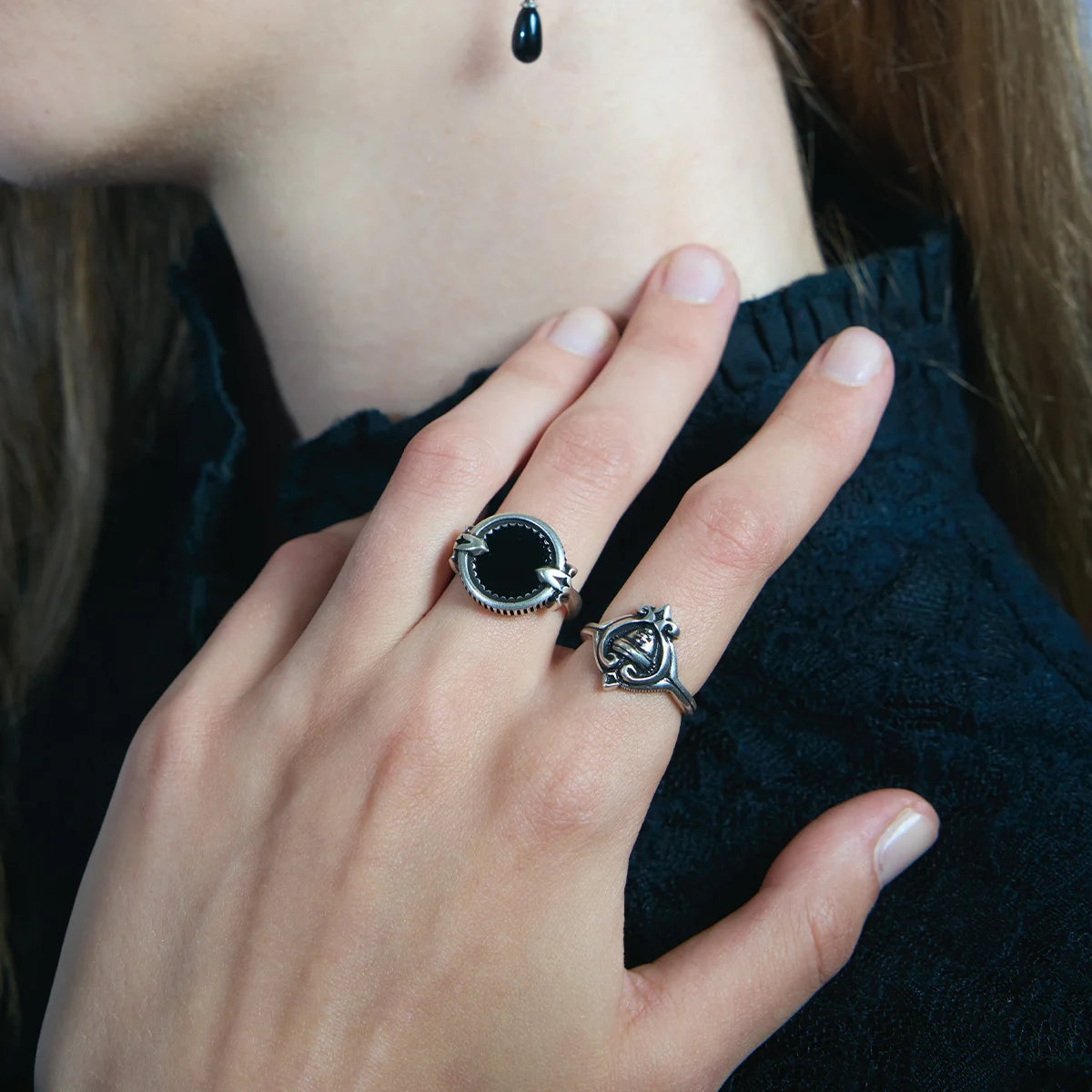 Close-up of an antiqued silver Scrying Mirror Ring worn on the hand, featuring a round black obsidian centerpiece.