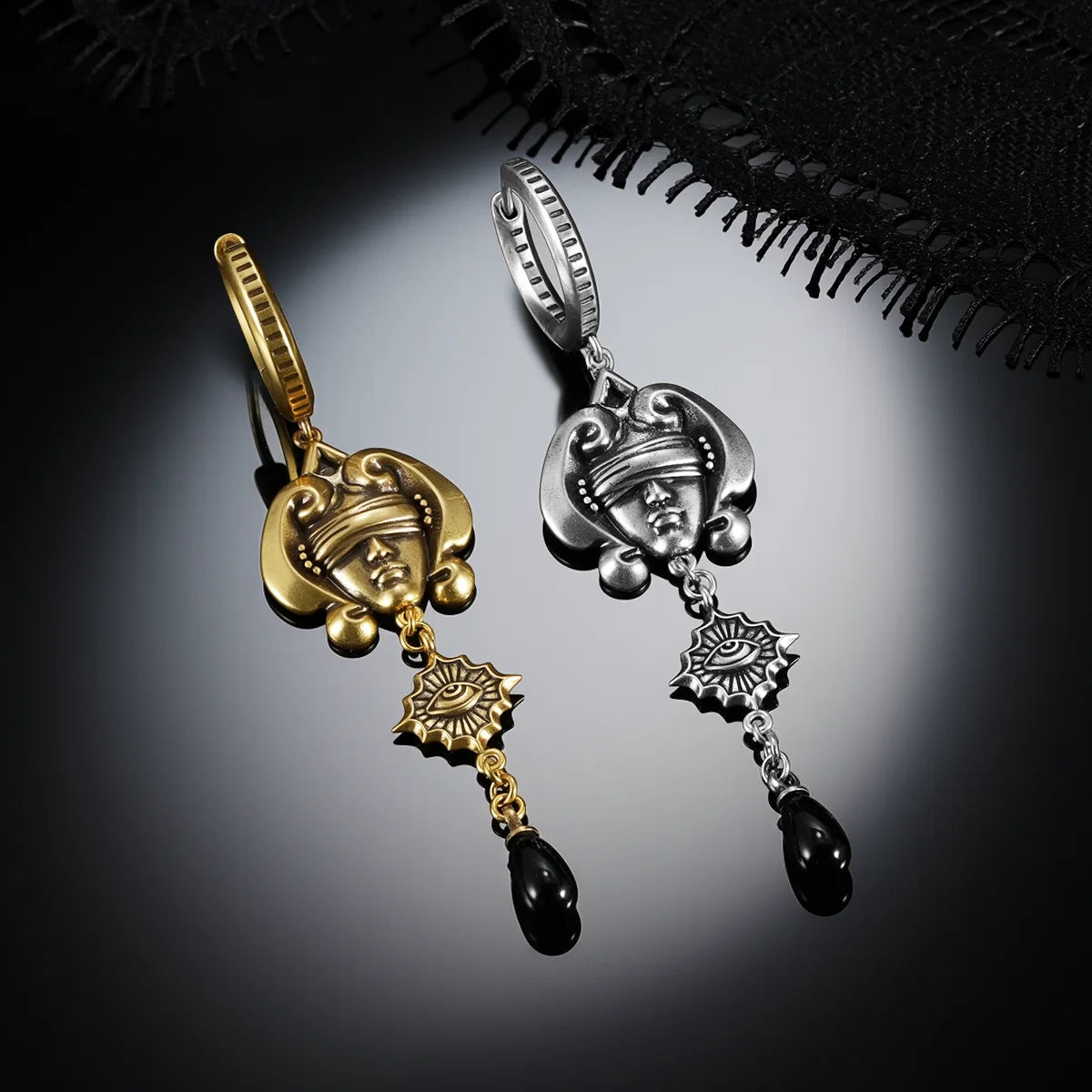 Antiqued silver- and gold-tone Second Sight Drop Earrings displayed together against black lace on a dark reflective surface.