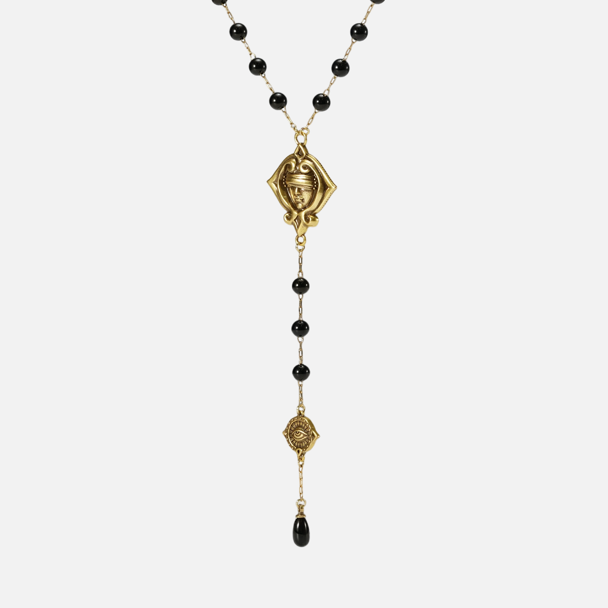 Full-length front view of the gold-tone Second Sight Lariat Necklace with black beads, linked emblems, and a black teardrop.