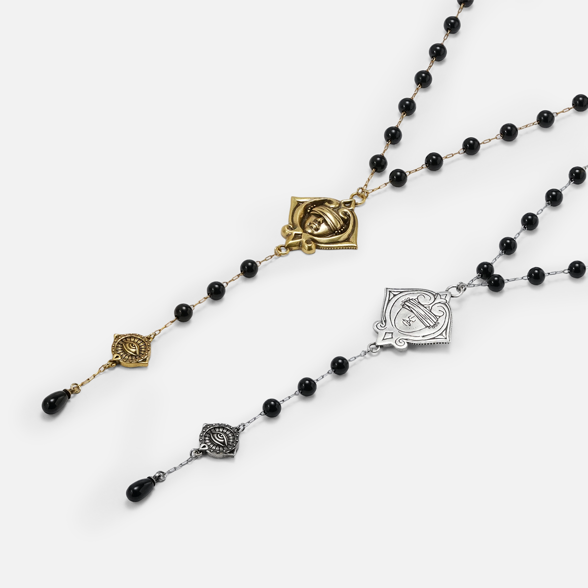 Antiqued silver- and gold-tone Second Sight Lariat Necklaces displayed from angled views on a light background.