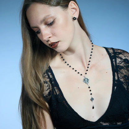 Antiqued silver-tone Second Sight Lariat Necklace worn in a downward-looking portrait, highlighting its elongated drop design.