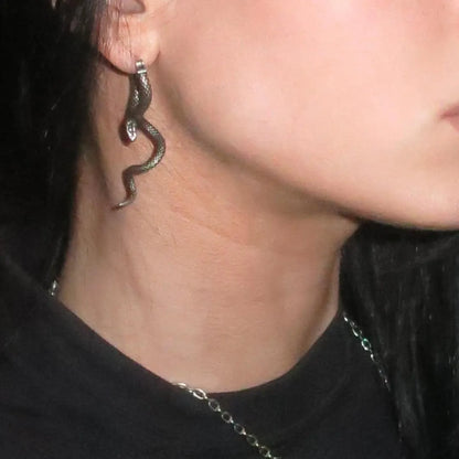 Silver Serpent Grace Earrings styled on model with flowing snake drop design and antique gothic jewelry look