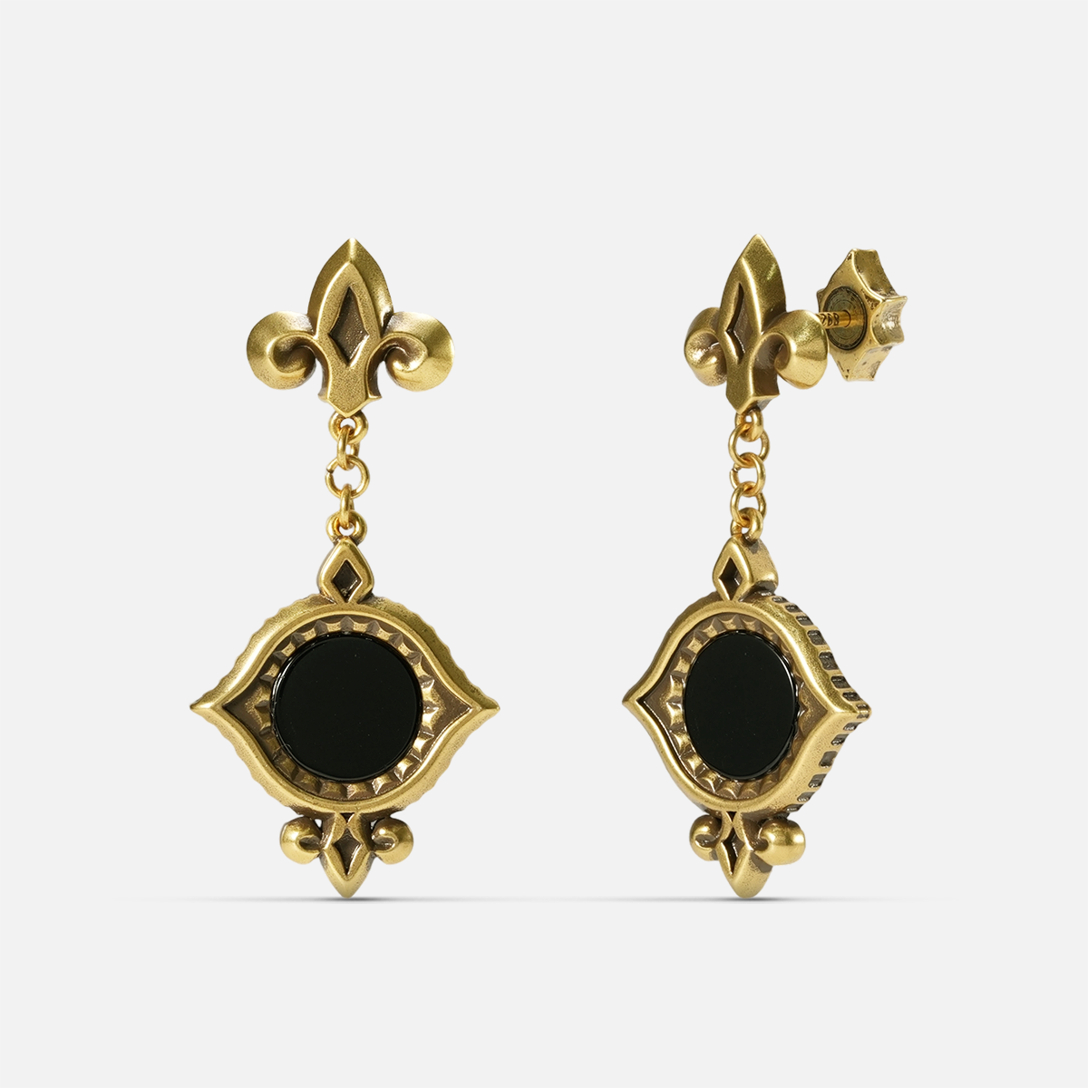 Gold-tone Silent Lens Drop Earrings shown from front and side views with round black obsidian centers and pointed eye-shaped frames.