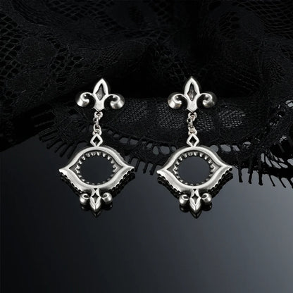 Antiqued silver-tone Silent Lens Drop Earrings displayed as a pair against black lace on a dark reflective surface.