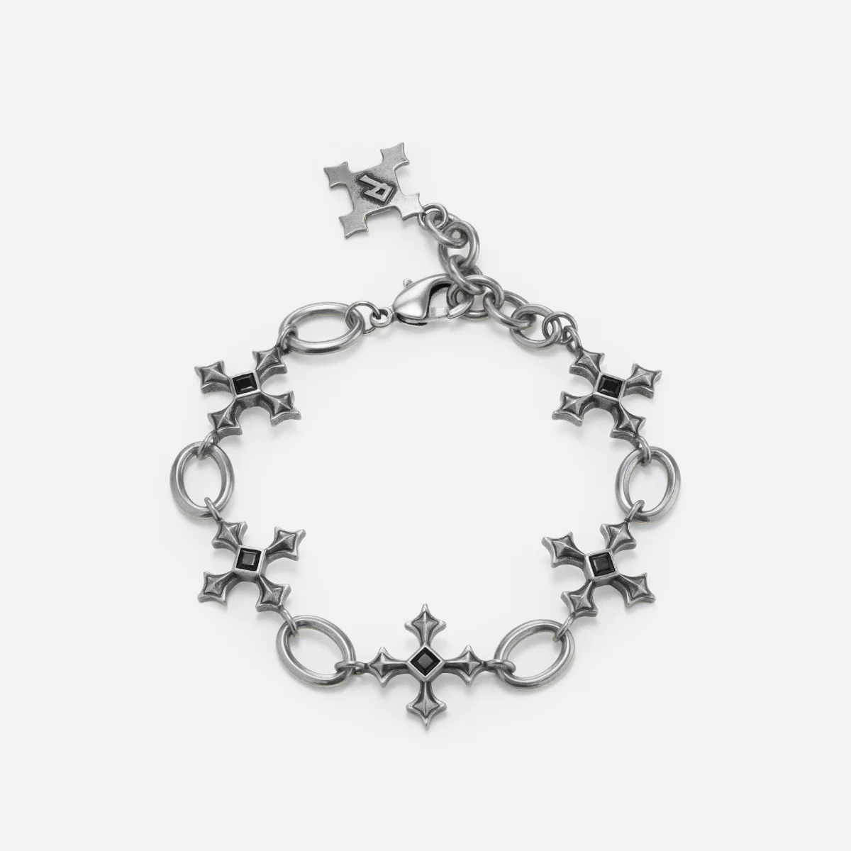 Silent Litany Bracelet in antiqued silver with gothic cross-inspired links and black obsidian, shown in a full circle on whit