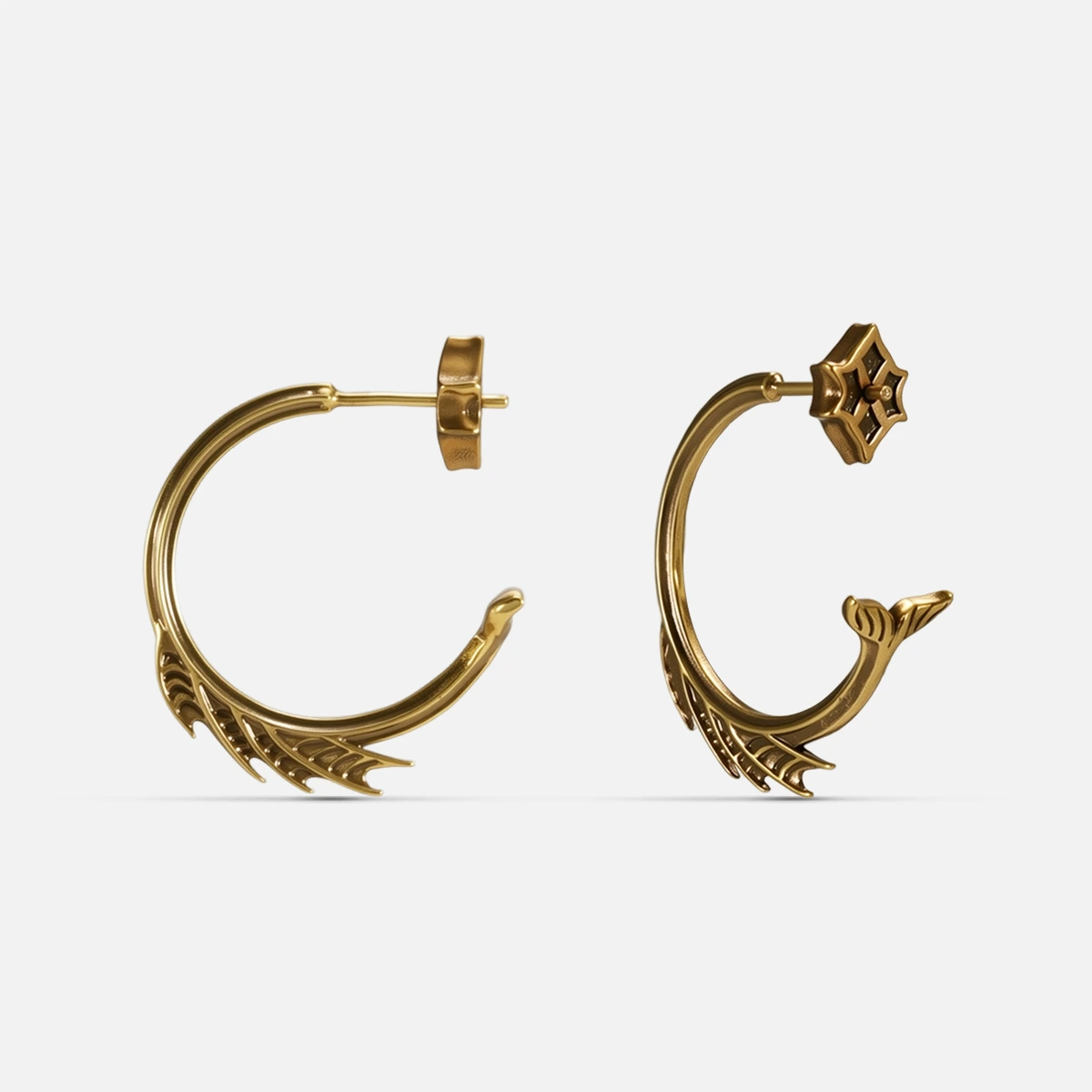 Gold Siren Crest Earrings with fin-like ridges, curved half-hoop design, and 925 silver posts on a clean background.