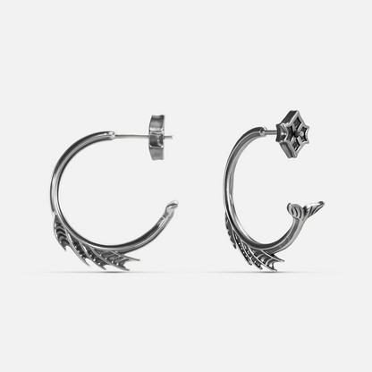 Silver Siren Crest Earrings with fin-like ridges, sculptural half-hoop shape, and 925 silver posts on a clean background.