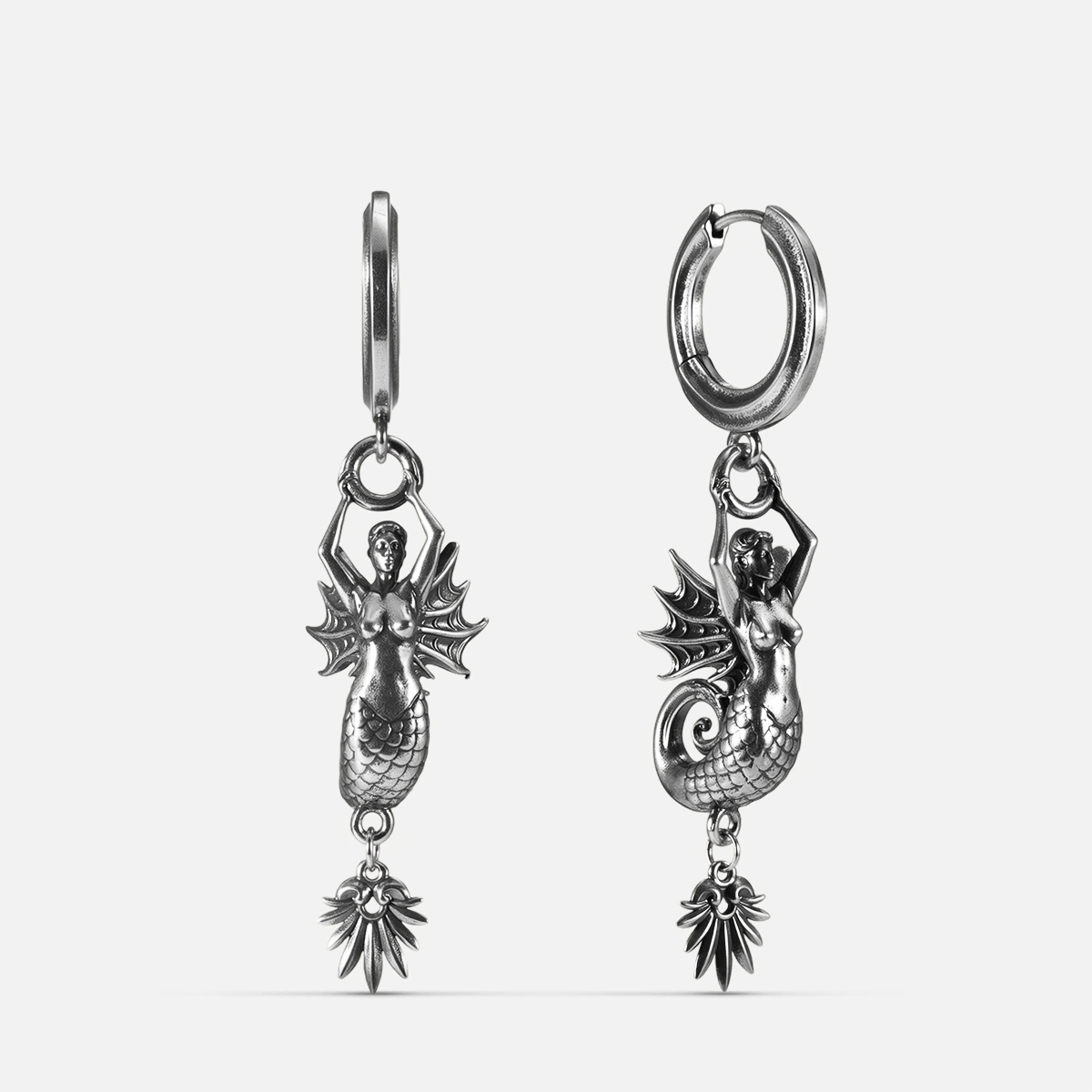 Silver Siren's Dirge Earrings with sculpted siren figure, scaled tail, sharp fins, dangling charm, and hoop design on a clean background.