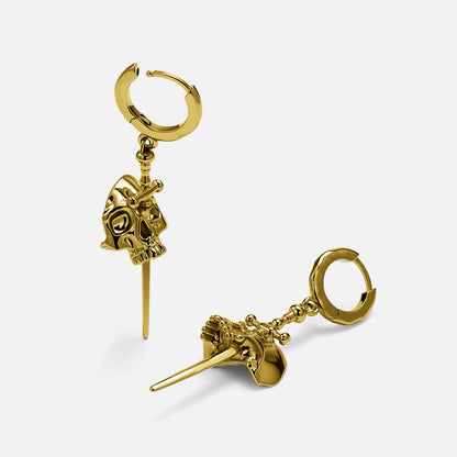 Gold-tone skull dagger earrings laid at angles showing hoop and pendant detail