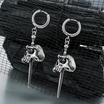 Pair of silver Skull Dagger hoop earrings displayed against black mesh