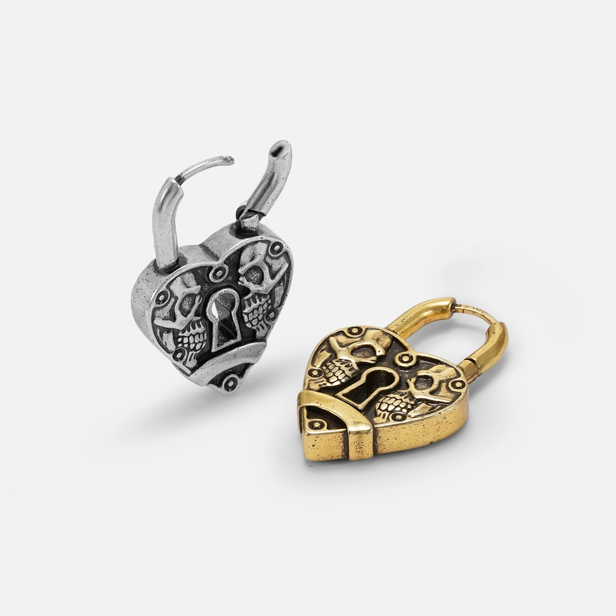 Silver and gold Skull Heartlock hoop earrings shown open and lying flat
