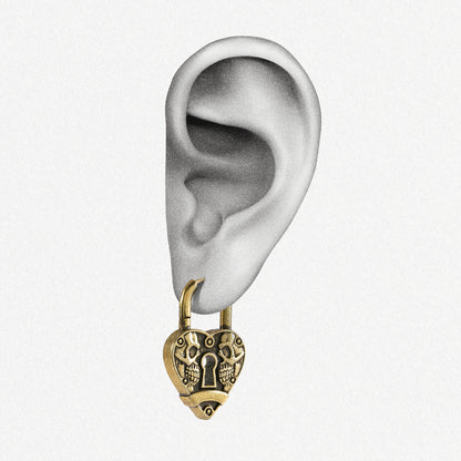 Gold Skull Heartlock hoop earring shown on an ear illustration