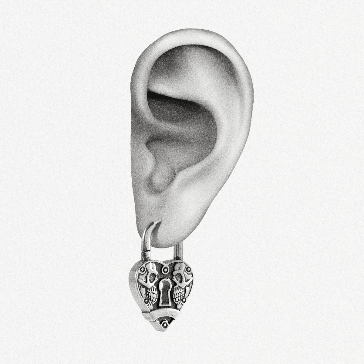 Silver Skull Heartlock hoop earring shown on an ear illustration