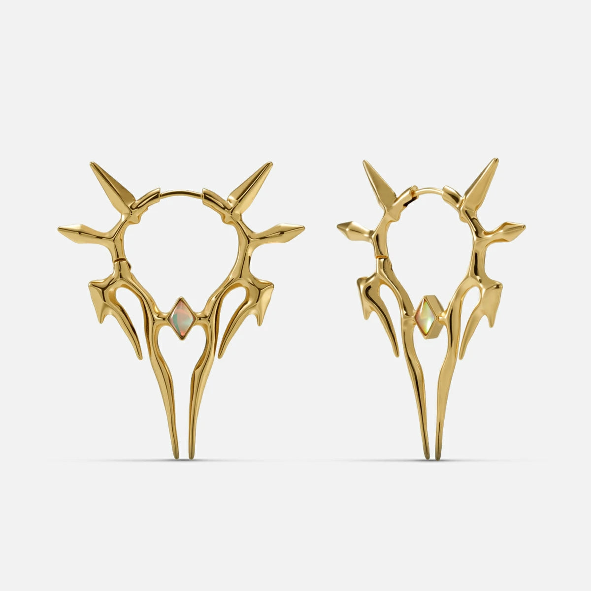 Pair of gold-tone spiked hoop earrings with a small opal-like stone, shown front and side view on a plain background