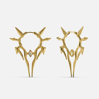 Pair of gold-tone spiked hoop earrings with a small opal-like stone, shown front and side view on a plain background