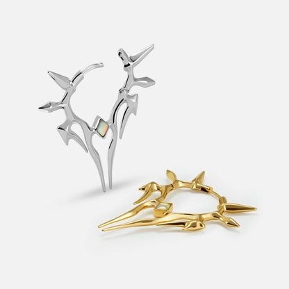 Silver and gold Solar Guardian earrings with angular spiked silhouettes