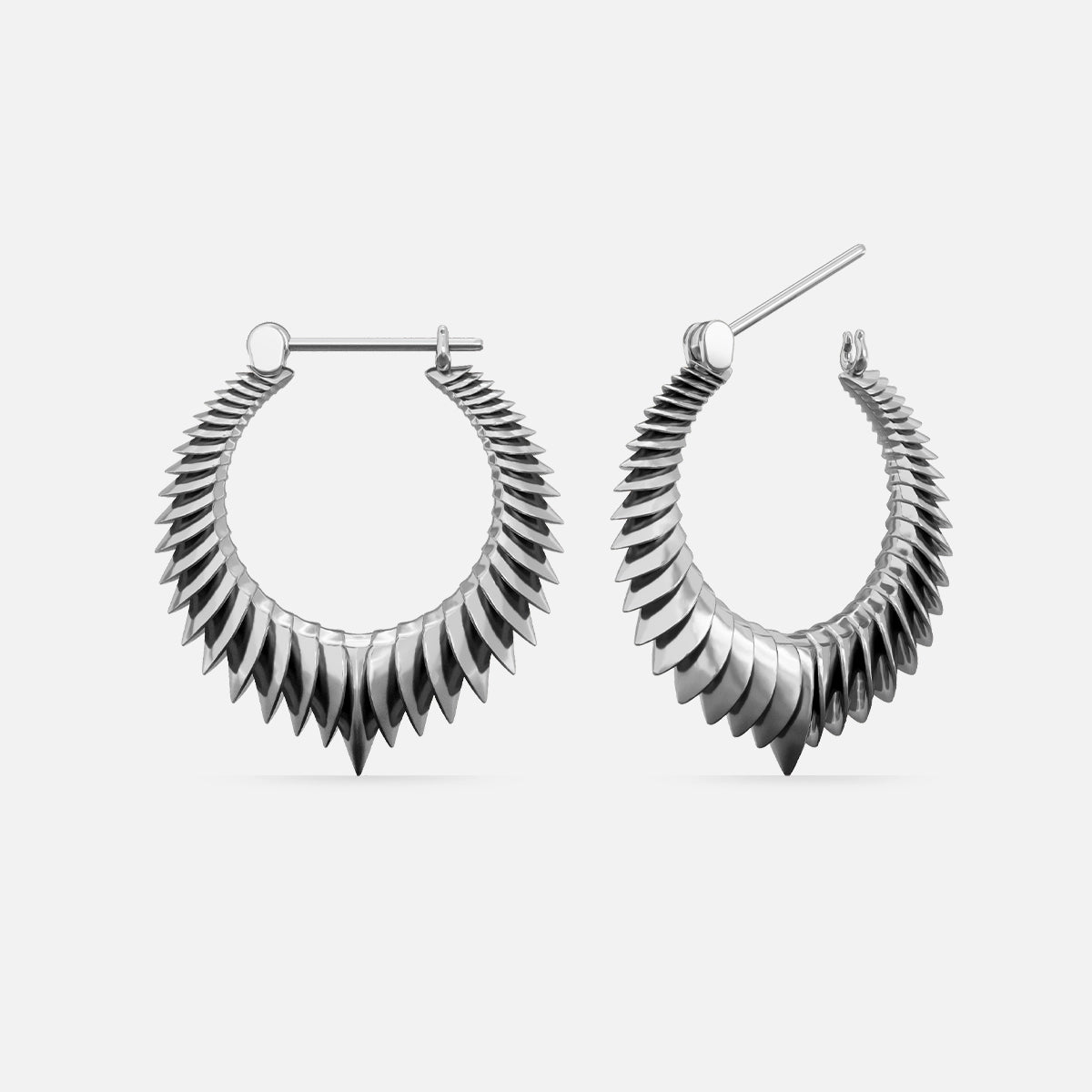 Pair of oxidized silver-tone hoop earrings with a layered spine motif, front and side view