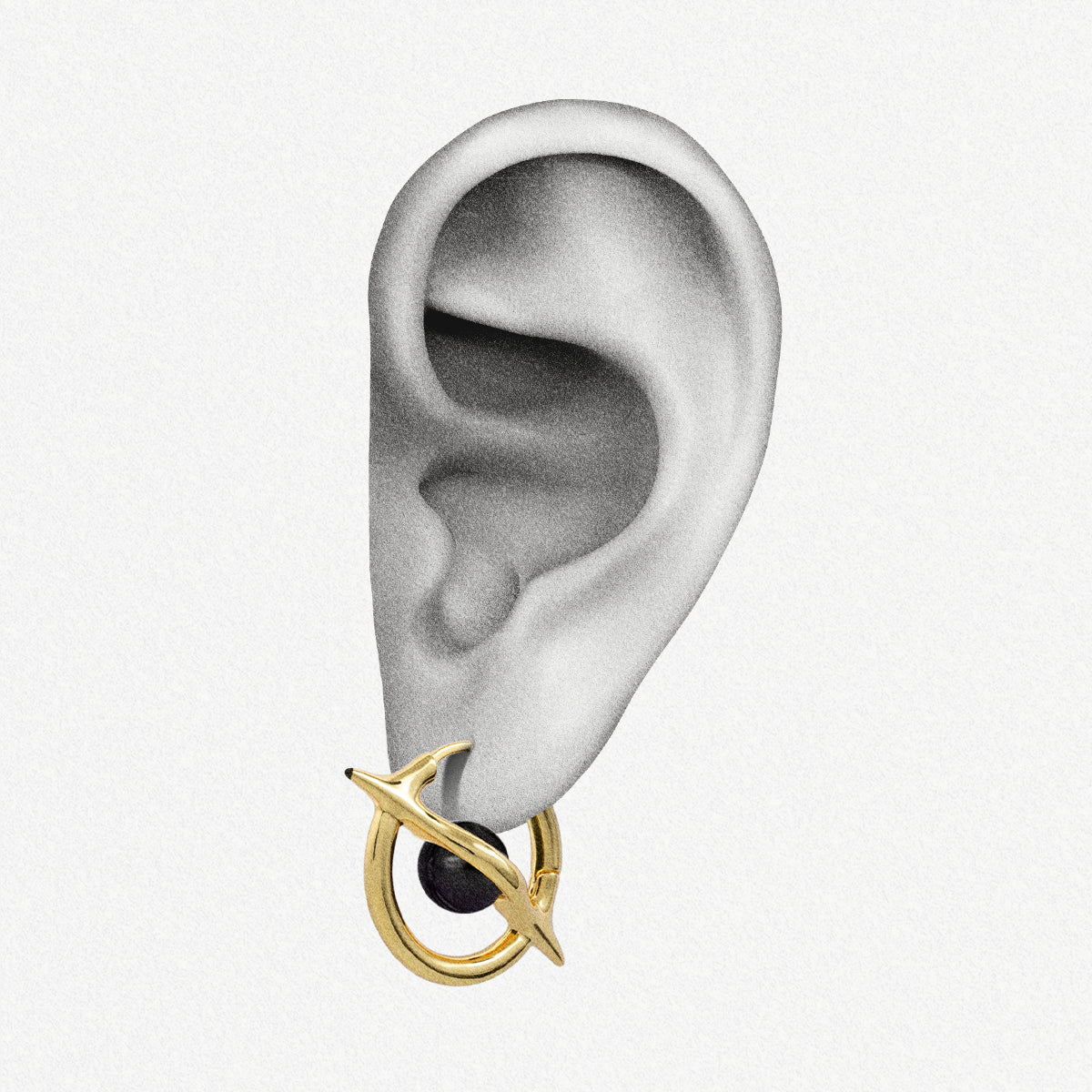 Gold Stellar Axis Earrings shown on ear placement with orbital gemstone hoop design