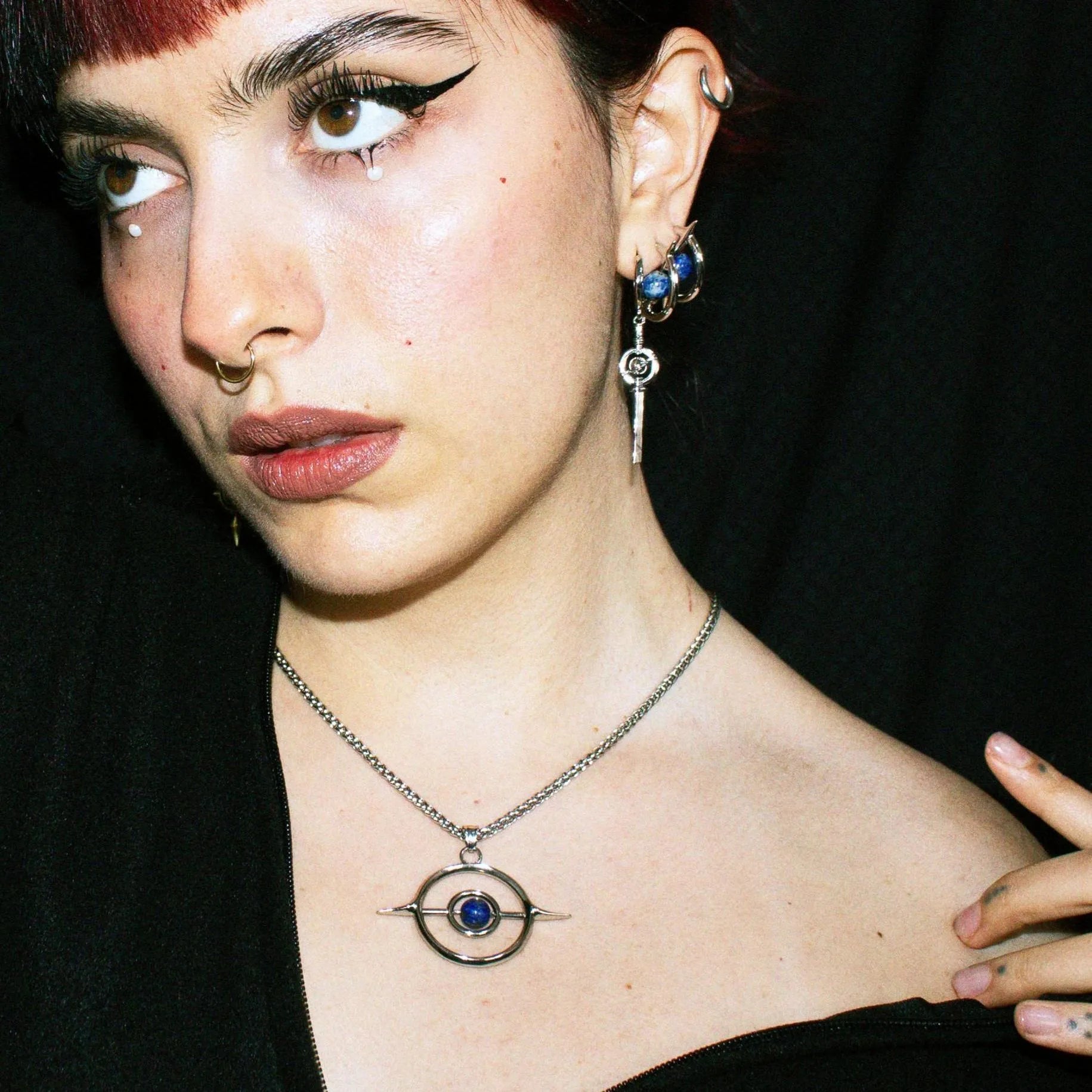 Stellar Axis Earrings styled on model with matching celestial jewelry and orbital gemstone design