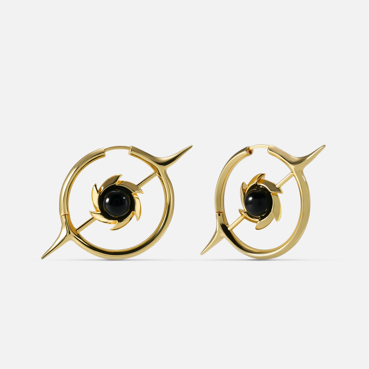 Gold-tone hoop earrings with a star design and round black stone center, front view pair