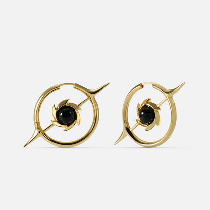 Gold-tone hoop earrings with a star design and round black stone center, front view pair