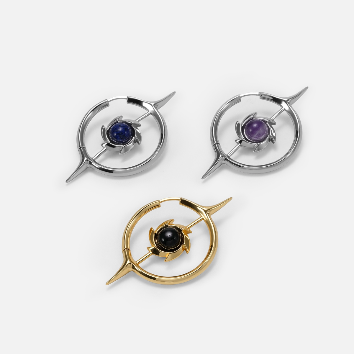 Silver and gold Stellar Constellation earrings with blue, purple, and black centers