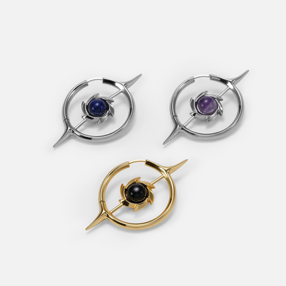 Silver and gold Stellar Constellation earrings with blue, purple, and black centers