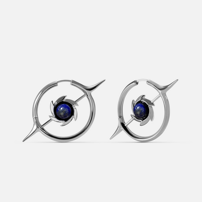 Silver-tone hoop earrings featuring a star motif and round blue stone at the center, front view pair