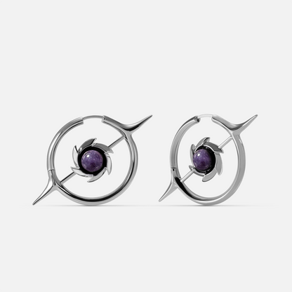 Silver-tone hoop earrings with a star-shaped pendant and round purple stone center, front view pair