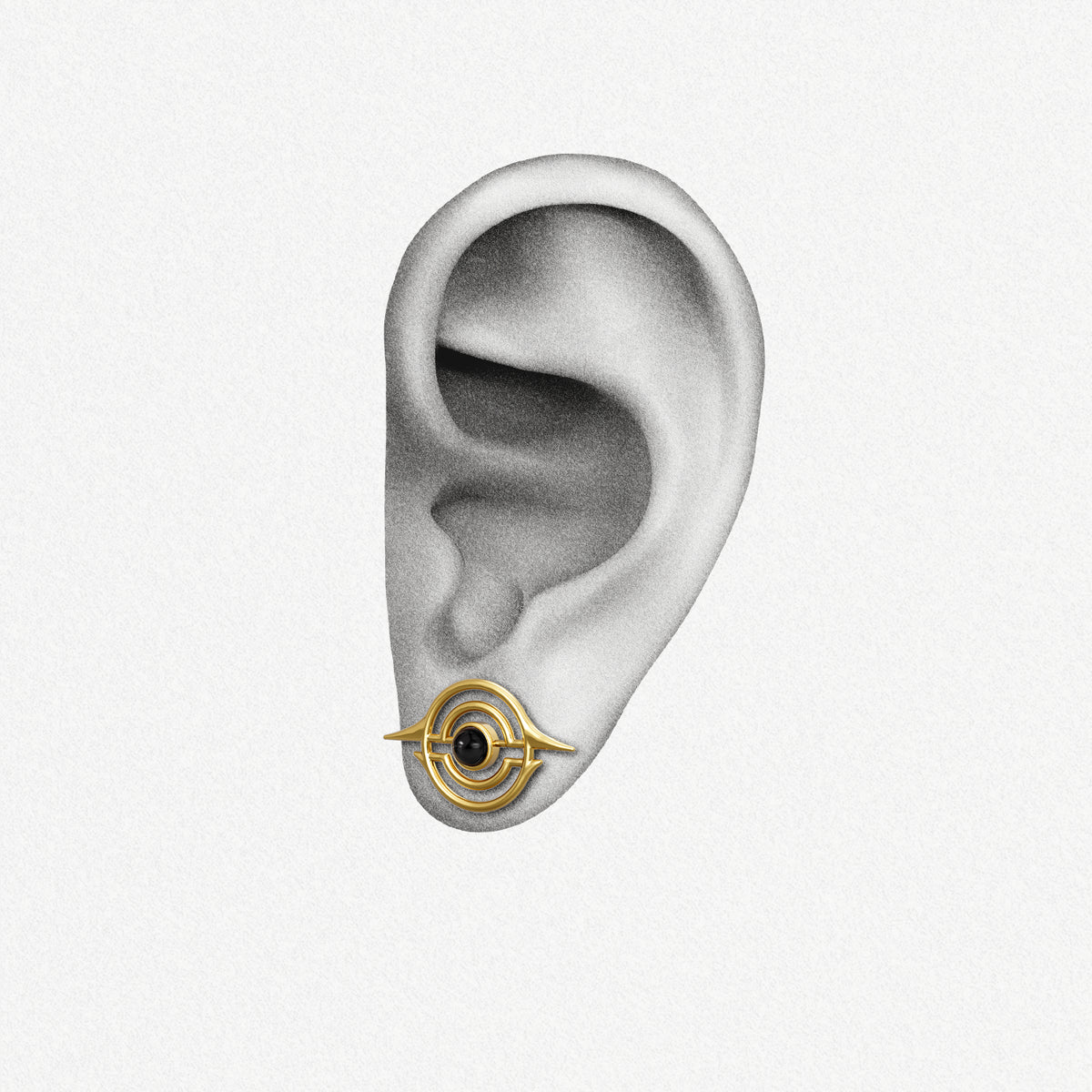 Gold Stellar Grace ear stud with black center shown on an ear illustration