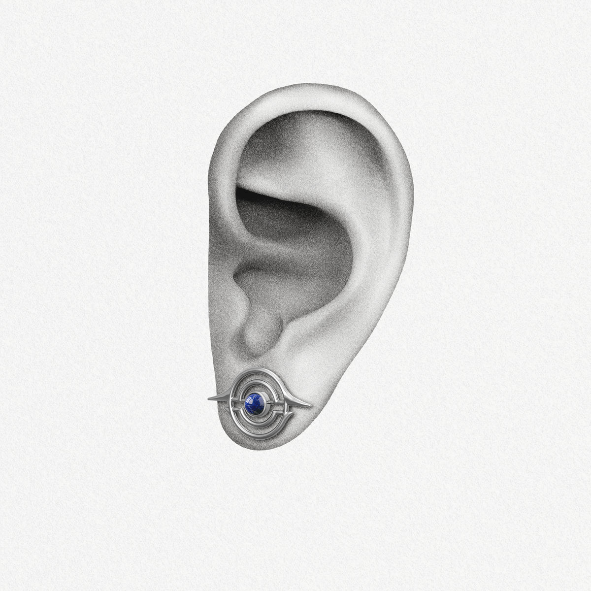 Silver Stellar Grace ear stud with blue center shown on an ear illustration