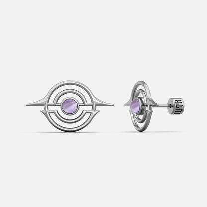 Silver-tone ear studs with concentric ring design and light purple stone center, front and side view