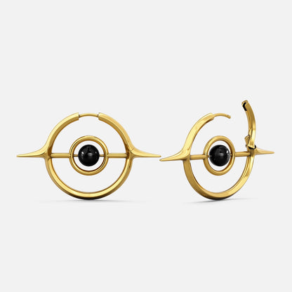 Gold-tone Stellar Grace hoop earrings with spike details and a black stone center, shown front and side view