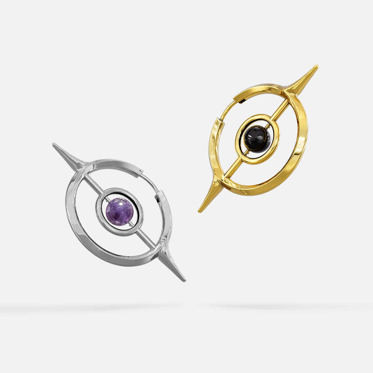 Silver and gold Stellar Grace hoop earrings with purple and black center accents