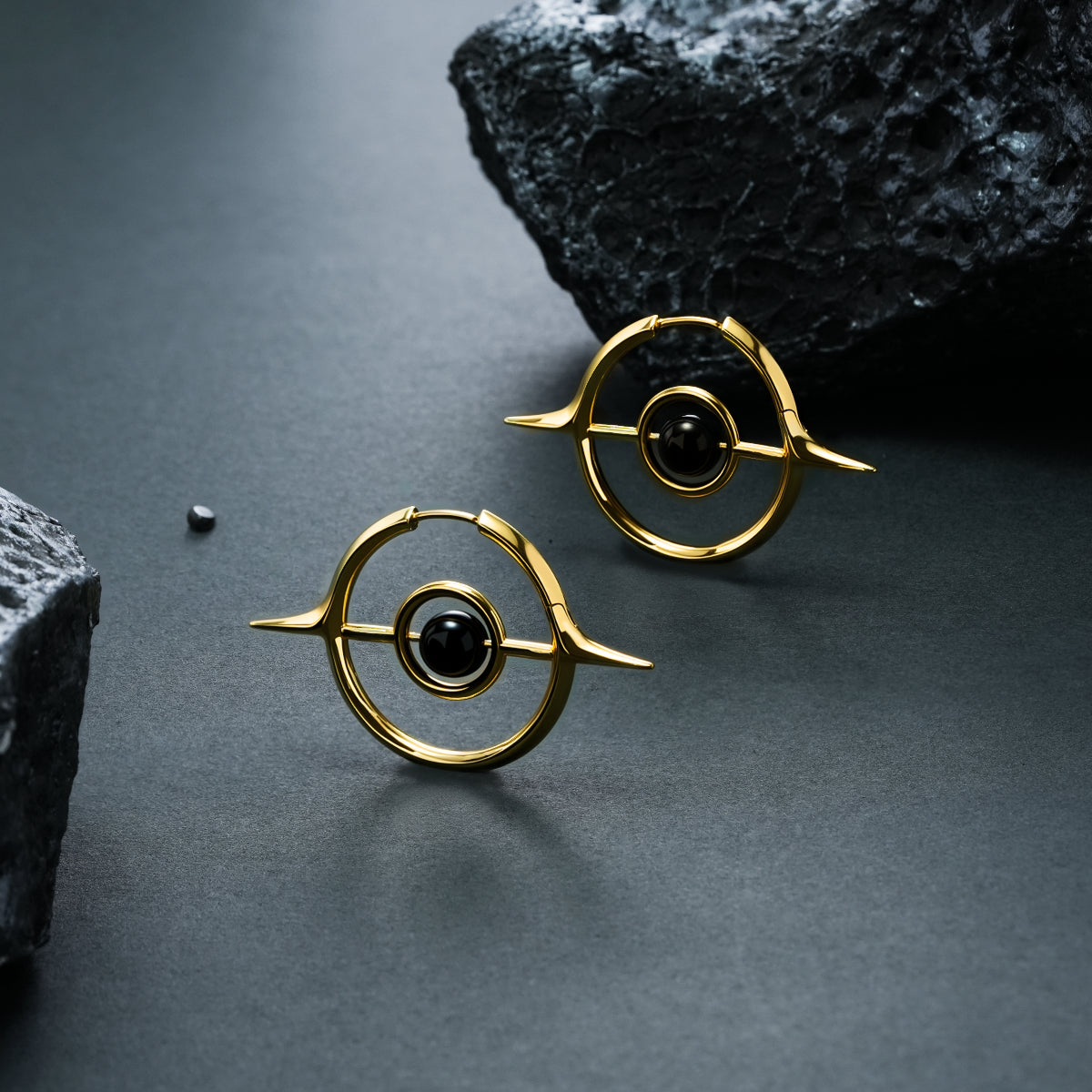 Pair of gold Stellar Grace hoop earrings with black center accents