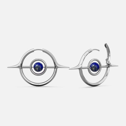 Silver-tone Stellar Grace hoop earrings with spike accents and a blue stone center, shown front and side view