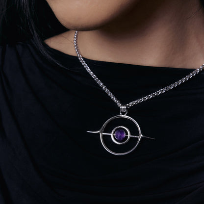 Stellar Grace Necklace worn on a model, showing the open circle pendant with a purple stone against a black top