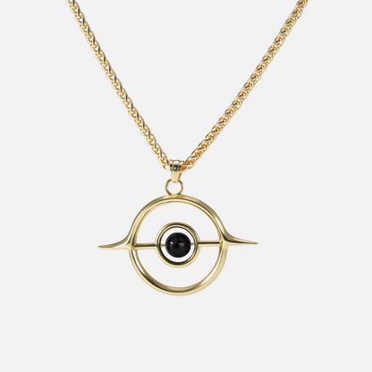 Gold Stellar Grace necklace with circular orbit pendant and black center