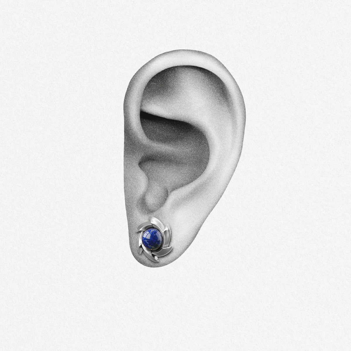 Silver Stellar Nova ear stud with blue center shown on an ear illustration